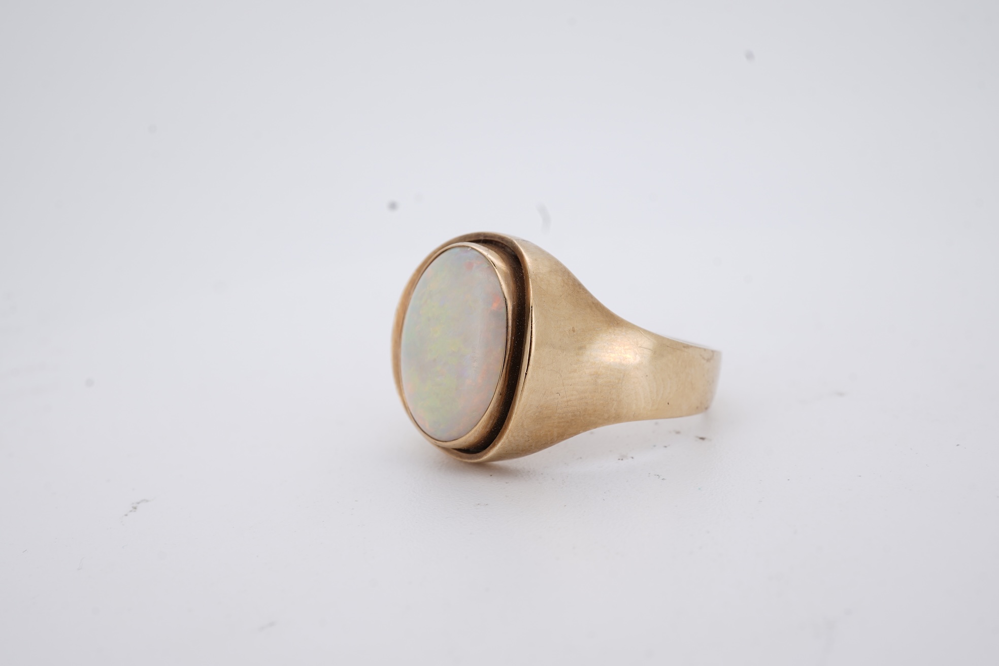 A 9ct and single stone cabochon white opal set ring, size K/L, gross weight 5 grams.